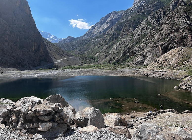A mountain lake surrounded by rocky terrain and a clear sky. 5