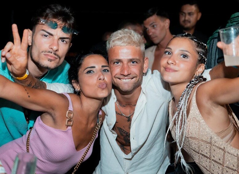 A group of people at a social event, some making peace signs. 3