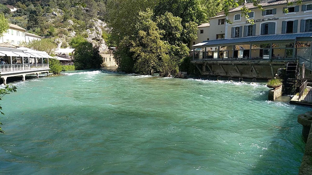 A river with a bridge and buildings along the banks. 3