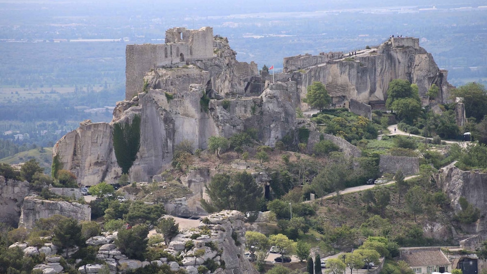 A historic fortress on a rocky hill with a panoramic view of the surrounding landscape. 2