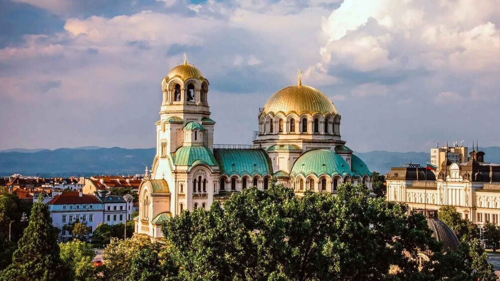 A historic cathedral with two prominent domes and a bell tower. 1