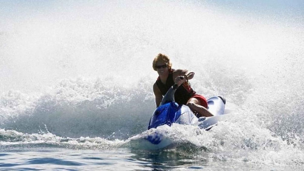 A person riding a jet ski on water. 5