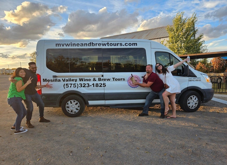 A white van with 'Mesilla Valley Wine & Brew Tours' and a phone number on it. 1
