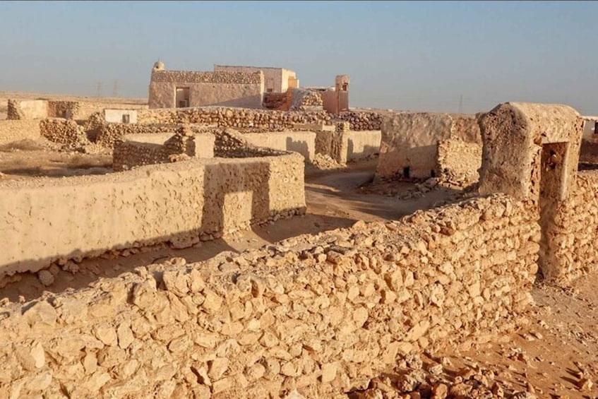 Ancient ruins with stone walls and a clear sky. 2