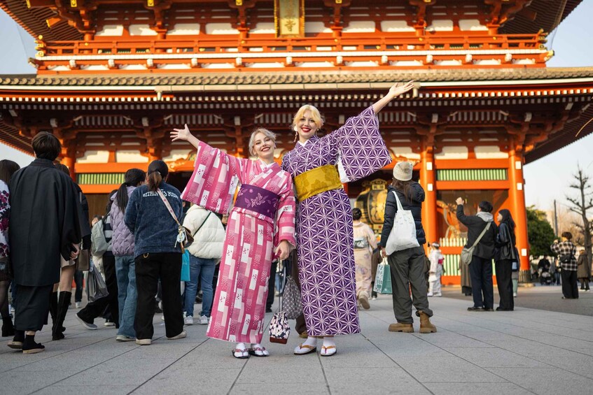 A group of people in traditional Japanese kimonos in front of a red torii gate. 1