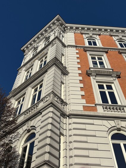 A corner of a building with ornate architectural details, including a corner turret and decorative moldings. 3