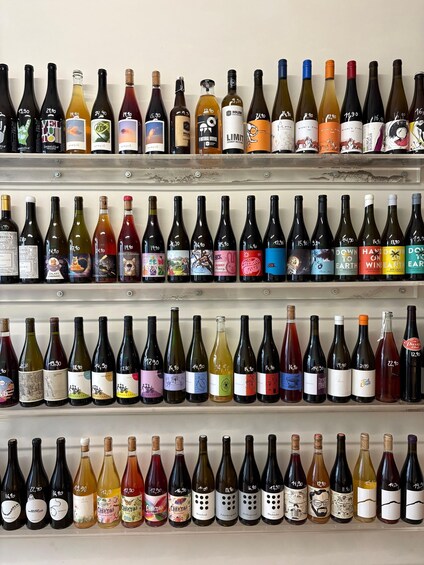 Multiple rows of wine bottles on shelves. 4