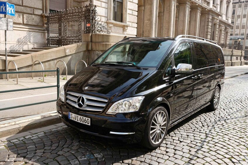 A black Mercedes-Benz V-Class van parked on a cobblestone street. 2