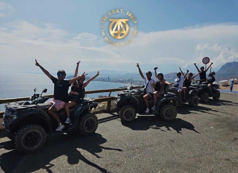 People on ATVs with a scenic waterfront and mountains in the background. 3