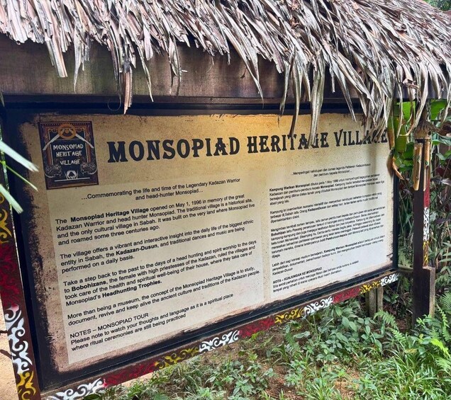 A signboard for Monsopiad Heritage Village, detailing its history and cultural significance. 2