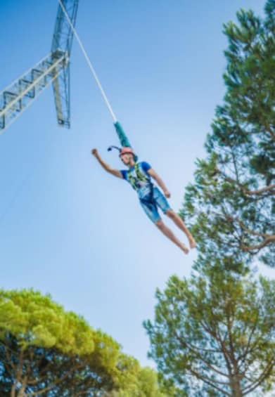 A person bungee jumping from a bridge. 3