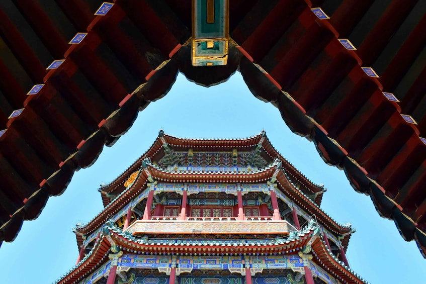 A traditional Chinese building with ornate red and blue decorations and a tiled roof. 3