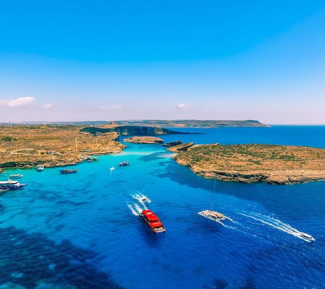 A coastal area with boats on the water and rocky terrain. 1