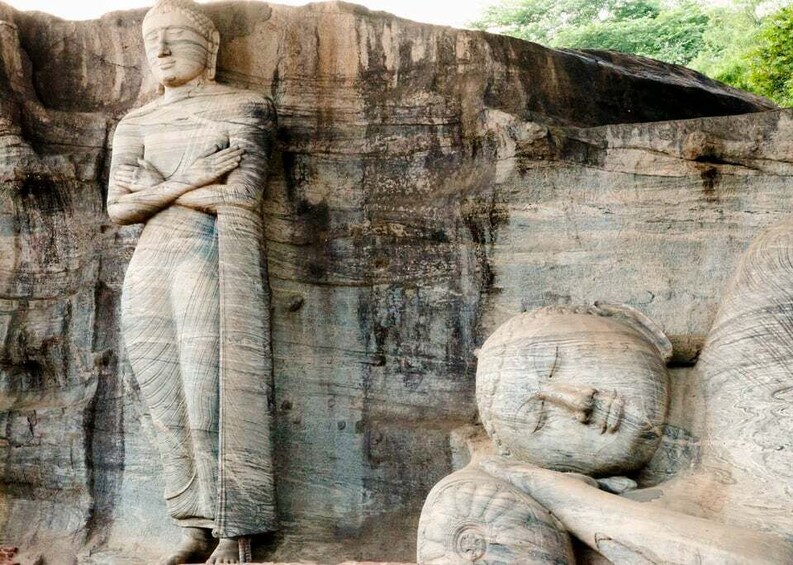 A large stone Buddha statue with a smaller Buddha statue carved into the rock behind it. 5
