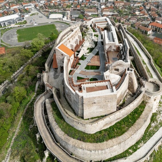 A historic fortress with a central courtyard, surrounded by walls and a moat. 2