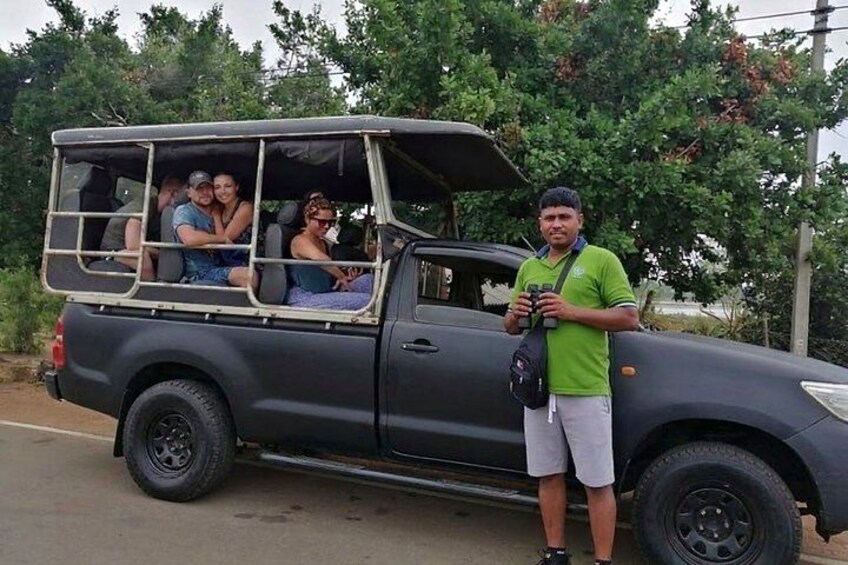 A vehicle with passengers and a person standing outside. 4
