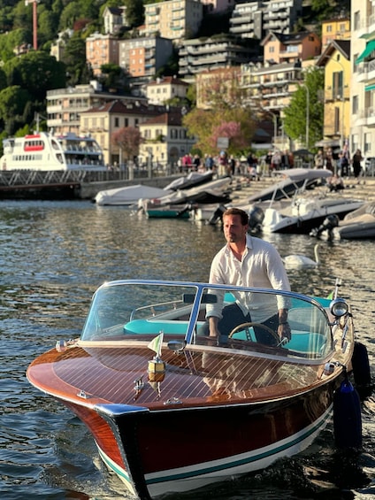 A vintage wooden boat on calm water with a cityscape in the background. 3