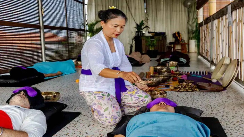 A person performing a massage on another individual lying on the floor. 5