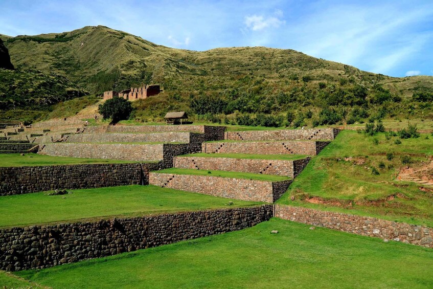 Ancient stone structures and terraced fields in a mountainous landscape. 2