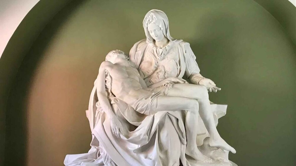 A marble statue of a woman holding a child. 5