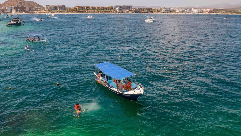 A boat with people on it in a body of water. 2