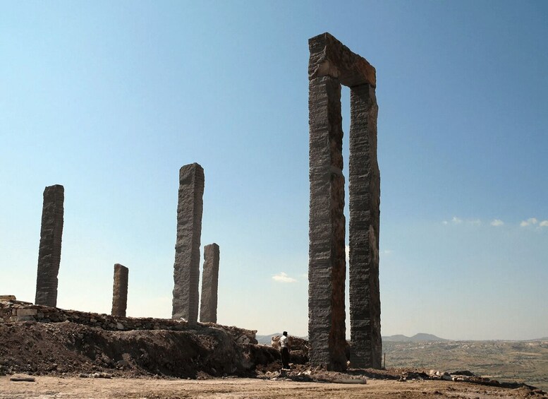 Ancient stone columns in a desert landscape. 4