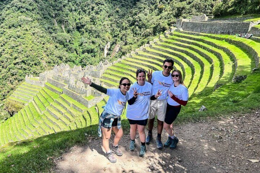 A group of people standing on a path with terraced fields in the background. 1