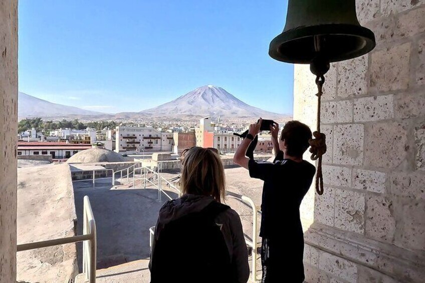 Two people taking a photo of a mountain. 5