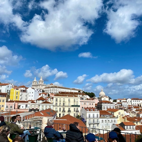 A cityscape with historic buildings and a clear blue sky. 1