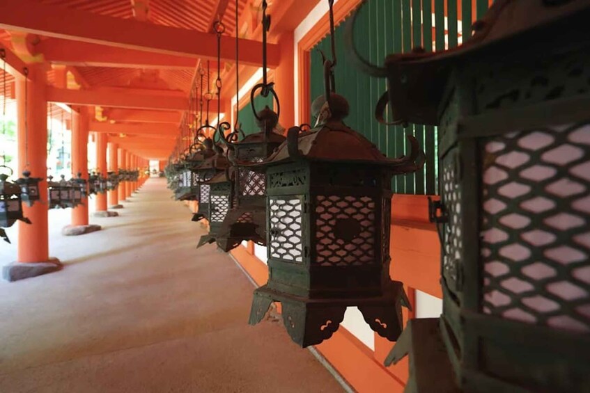 A corridor with hanging lanterns and orange pillars. 4