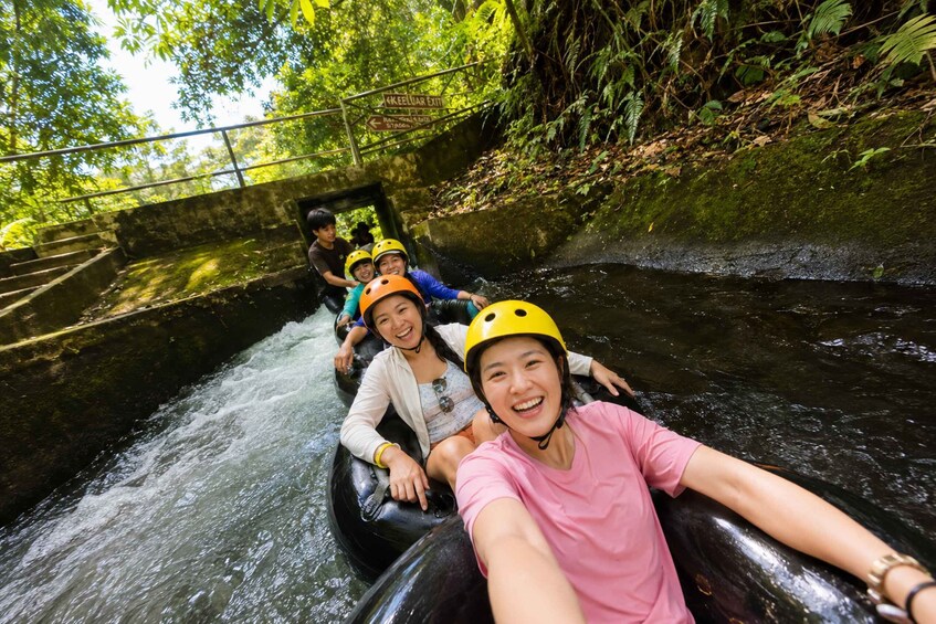 People rafting on a river surrounded by lush greenery. 2