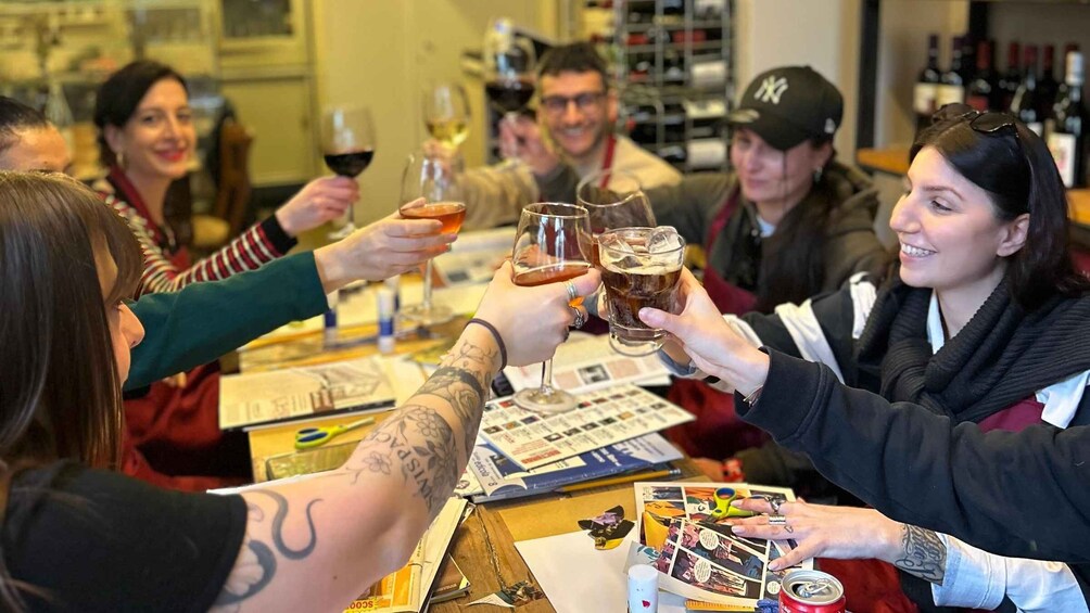 A group of people toasting with drinks at a table with magazines and a can of soda. 2