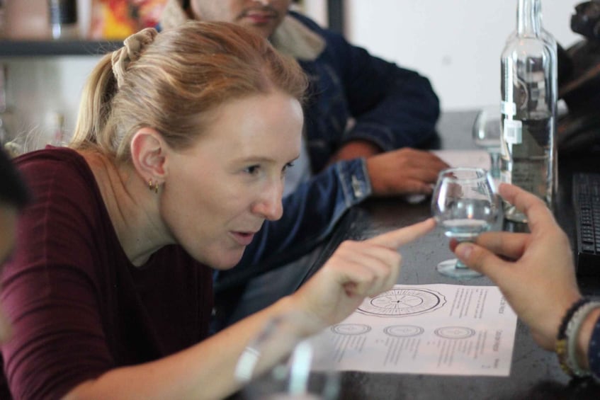 A person holding a wine glass at a table with a menu. 1
