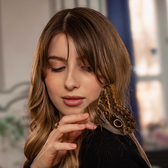 A person holding a butterfly. 5