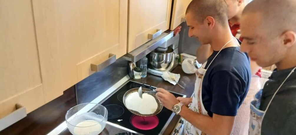 Two people in a kitchen preparing food. 1