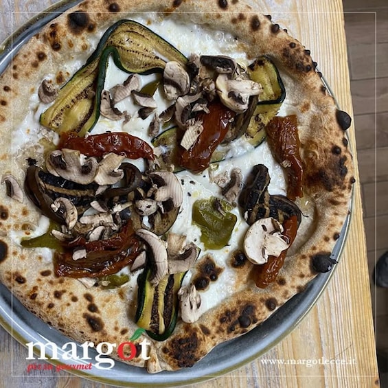 A pizza with various toppings on a metal tray. 2