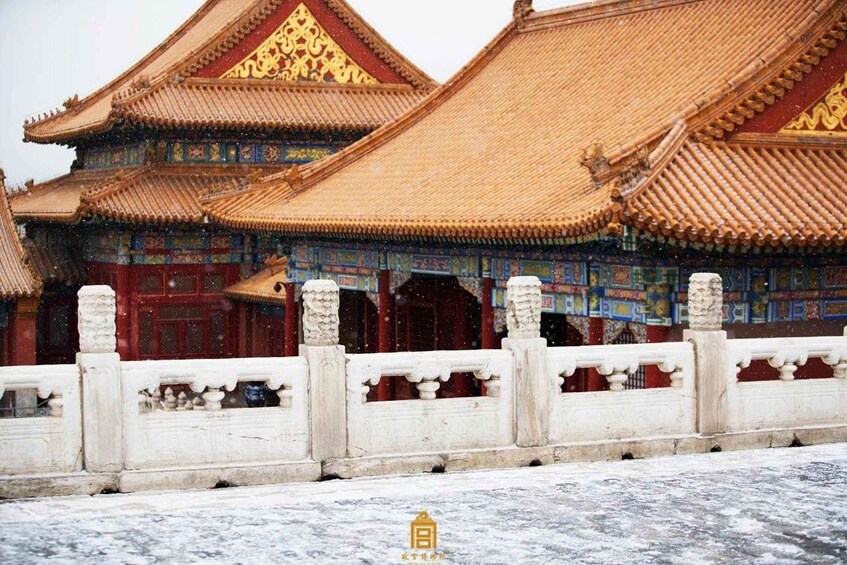 A traditional Chinese building with ornate golden roofs and intricate blue and red decorations. 4