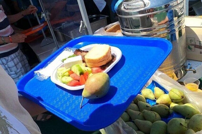 A blue tray with a sandwich, fruit, and a pear. 3