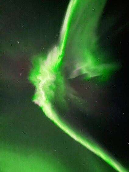 A green light streak against a dark background. 5