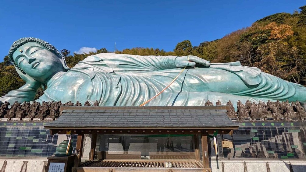 A large reclining Buddha statue with a shrine in front. 1