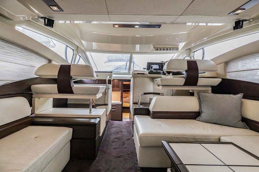 A luxurious interior with a central dining area, two sofas, and a small table. 5