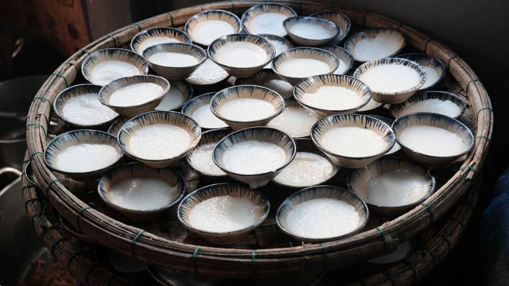 A woven basket filled with bowls of white powder, likely sugar or flour. 1