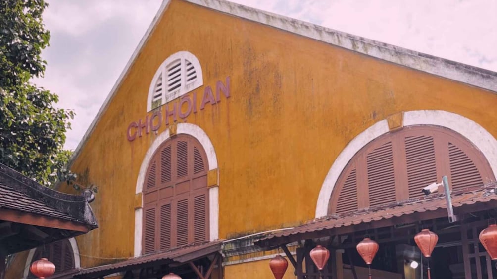 A building with the sign 'CHO HOIAN' and traditional wooden shutters. 2