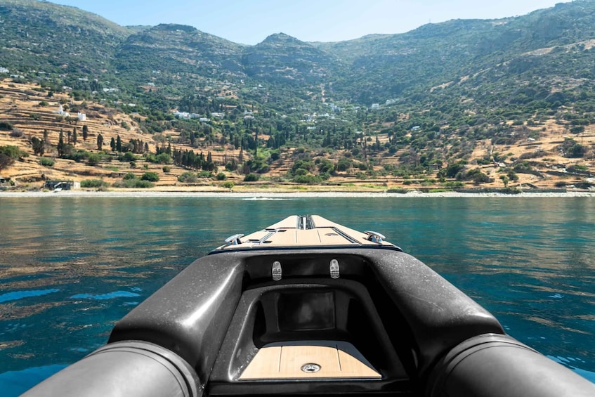 A boat on a calm lake with terraced hills in the background. 3
