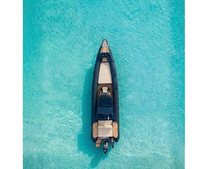 An aerial view of a boat on clear turquoise water. 1