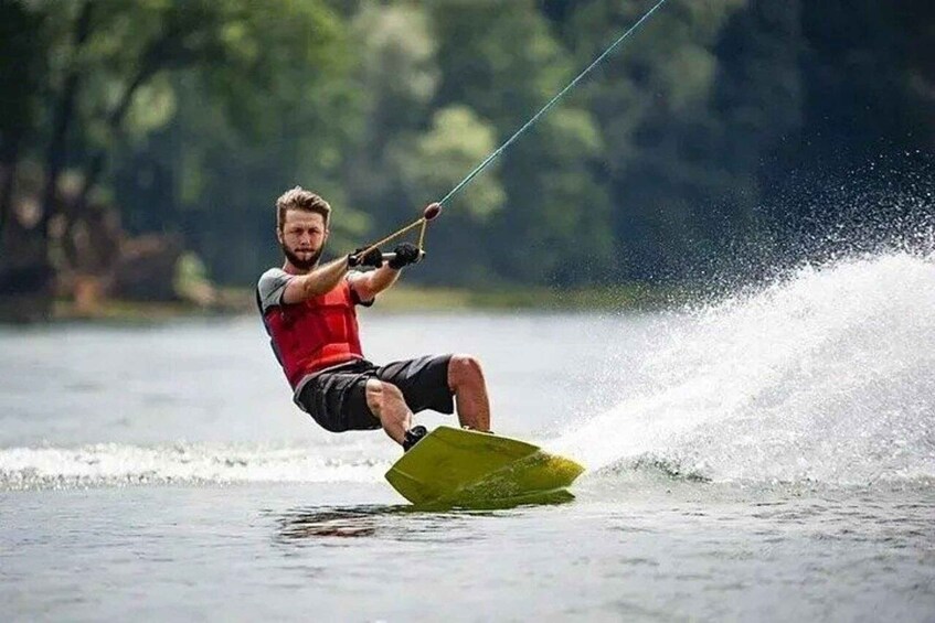 A person wakeboarding on a lake. 1