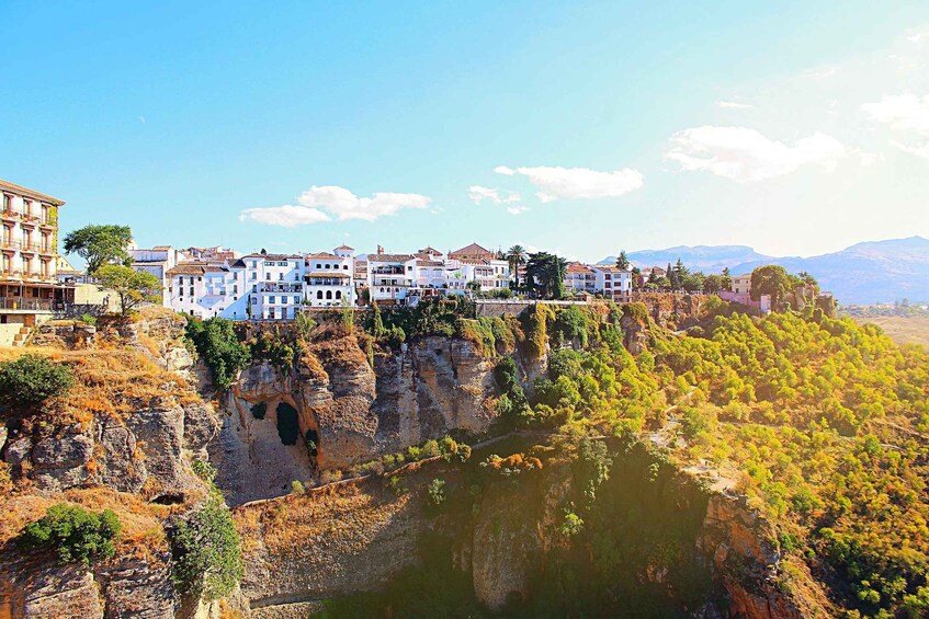 A coastal town with buildings on a cliff overlooking a river. 2