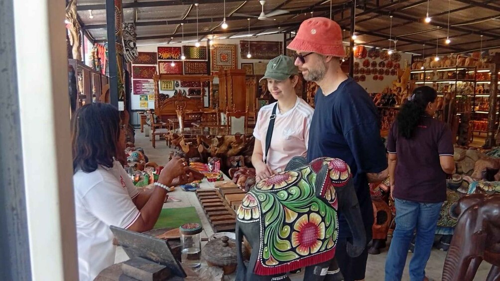 A market with wooden furniture and colorful textiles. 3