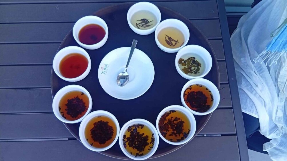 A circular arrangement of tea bowls on a tray. 5