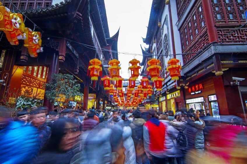 A crowded street with traditional architecture and red lanterns. 2